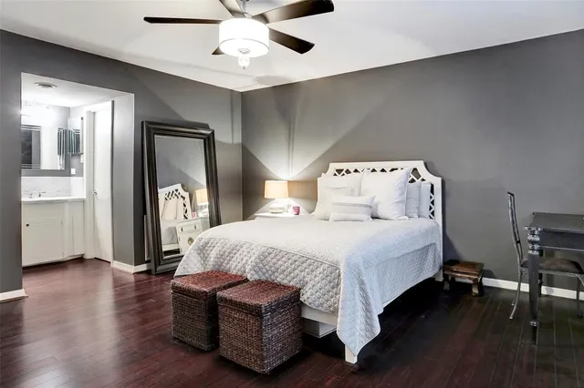 a bedroom with a bed wooden floor and table