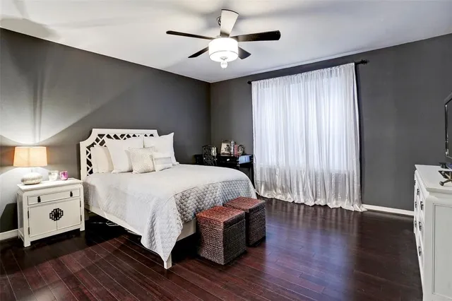 a spacious bedroom with a bed and a chandelier