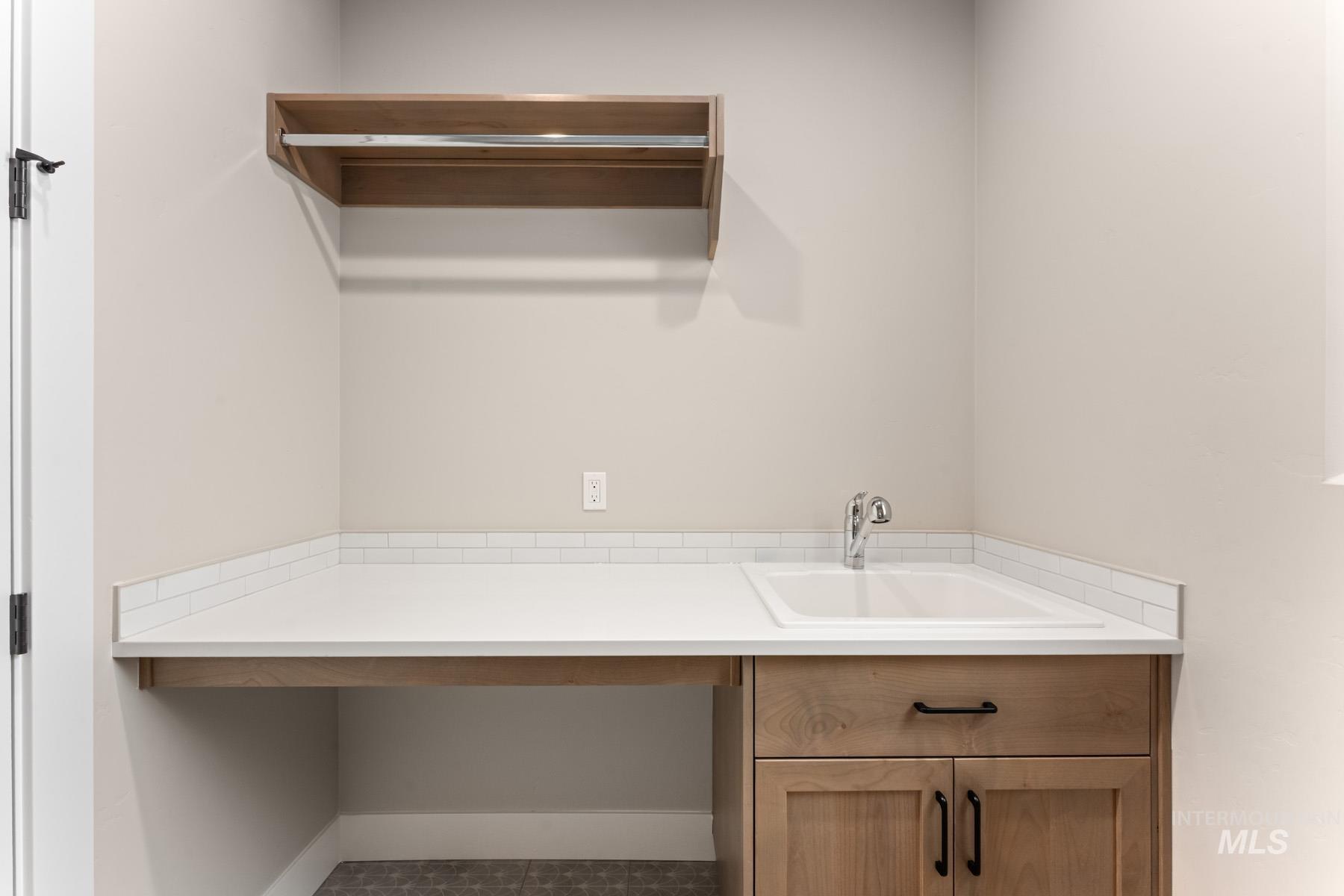 13366 North Spring Creek Way Boise, ID 83714 - Photo 27 of 44 Laundry room featuring a sink and baseboards