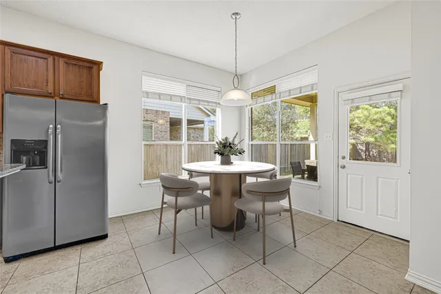 a kitchen with stainless steel appliances granite countertop a refrigerator and a stove top oven