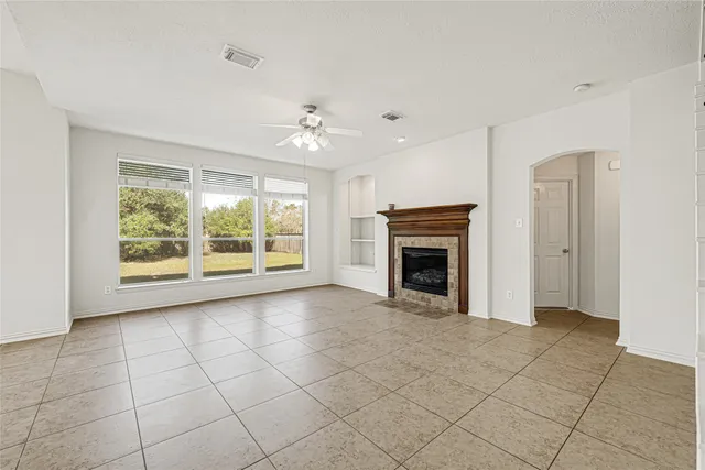 a living room with furniture two window and a fireplace