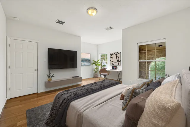 a spacious bathroom with a granite countertop tub a shower double sink and a large mirror