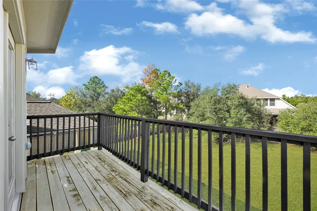 a view of a balcony with wooden floor