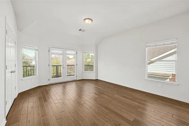 a spacious bedroom with a large bed and a large window