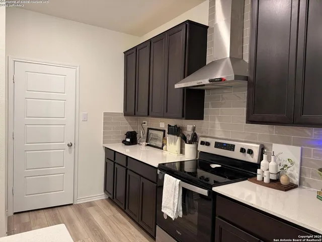 a kitchen with granite countertop a stove and a microwave