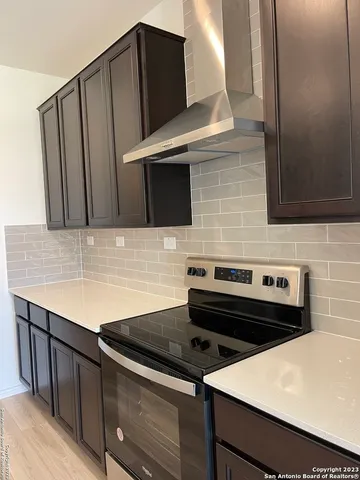 a large kitchen with kitchen island a sink stainless steel appliances and cabinets