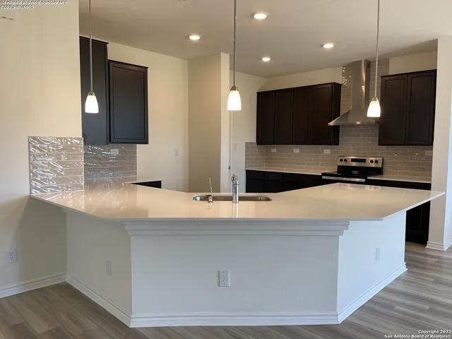 a living room with couches and a flat screen tv