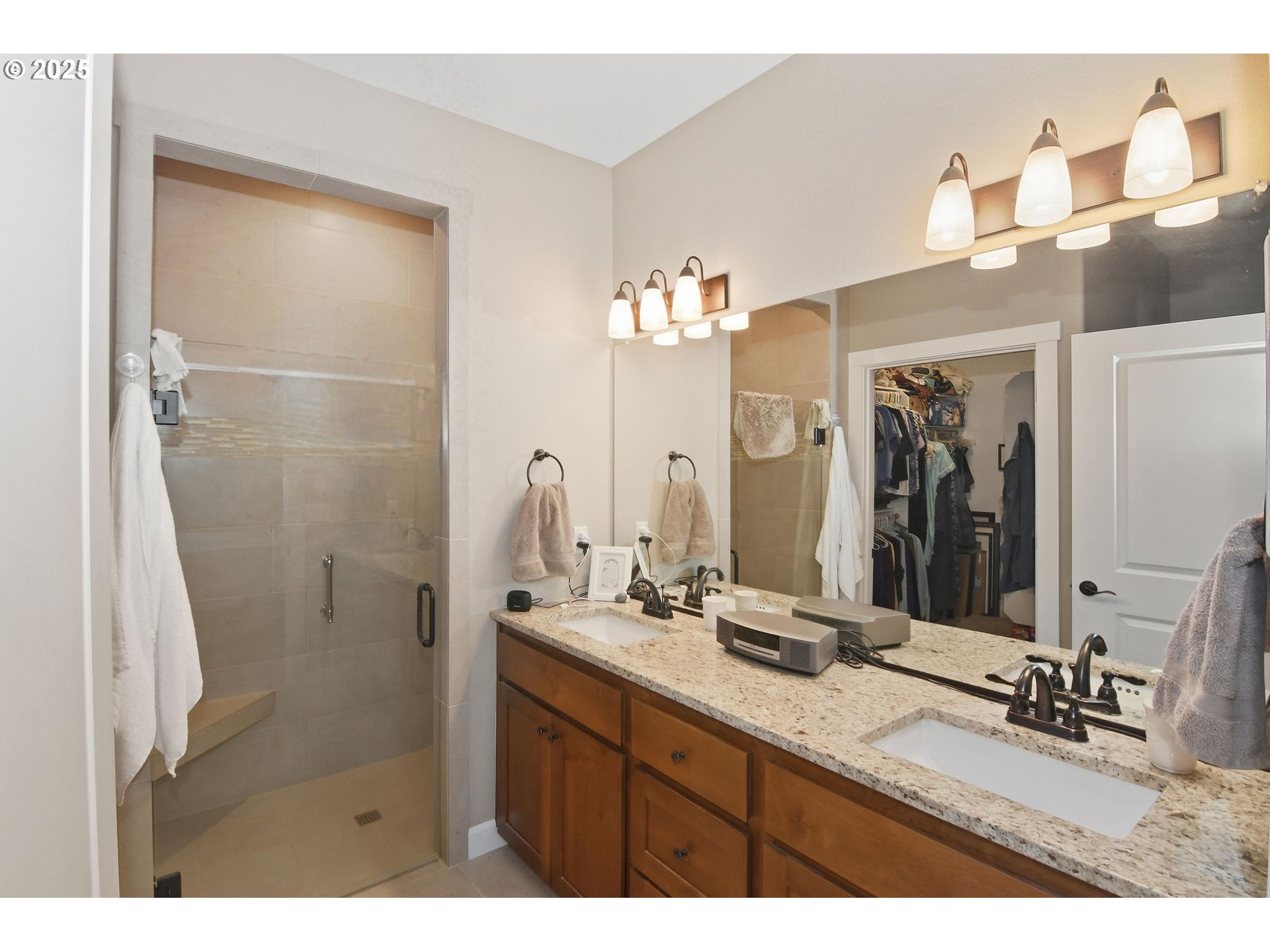 1618 Northeast 174th Street Ridgefield, WA 98642 - Photo 22 of 46 a bathroom with a granite countertop sink a mirror and shower