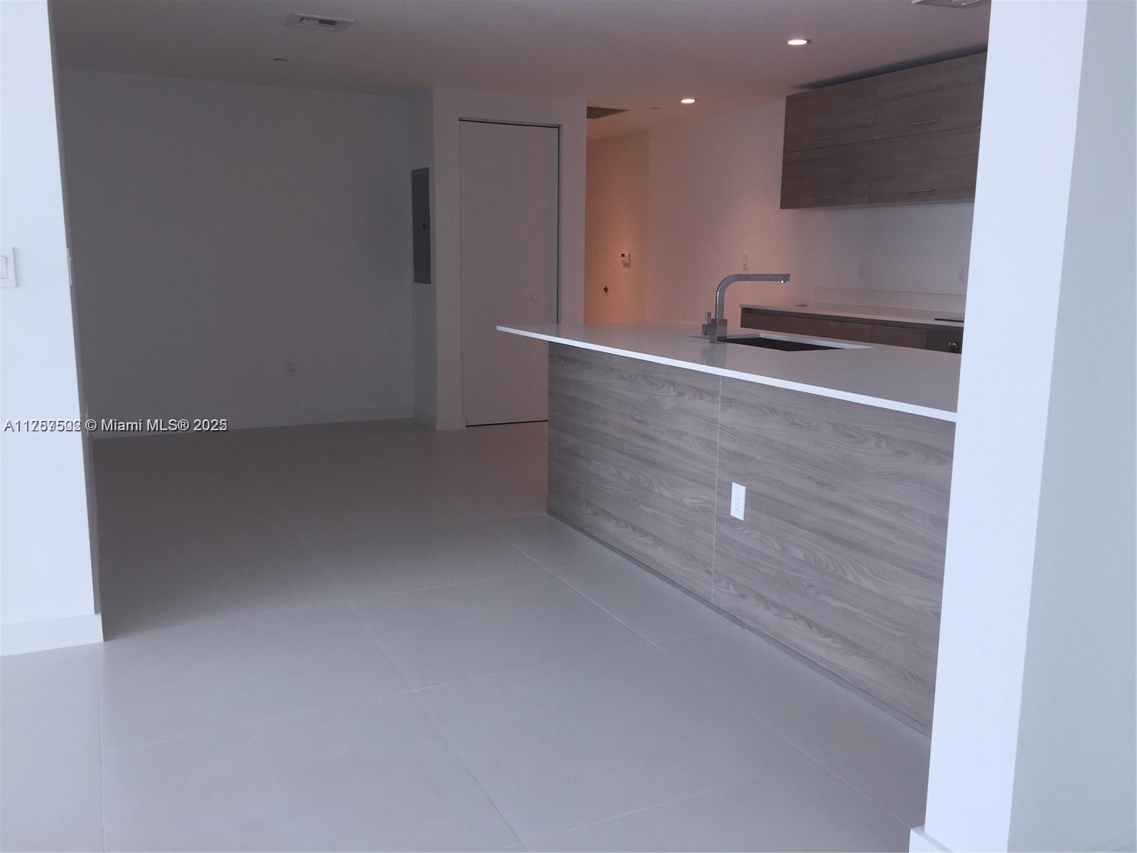 1300 South Miami Avenue, Unit 1910 Miami, FL 33130 - Photo 5 of 14 a view of kitchen with refrigerator and stove
