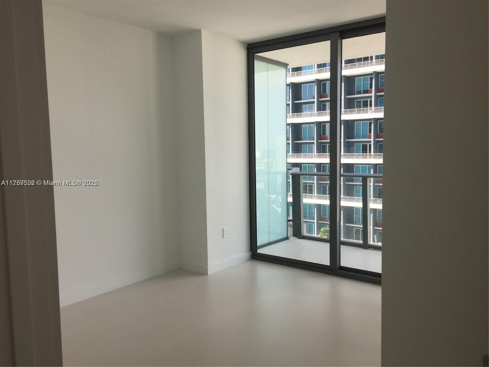 1300 South Miami Avenue, Unit 1910 Miami, FL 33130 - Photo 7 of 14 an empty room with window