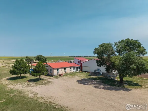 an aerial view of a house with garden space and outdoor seating