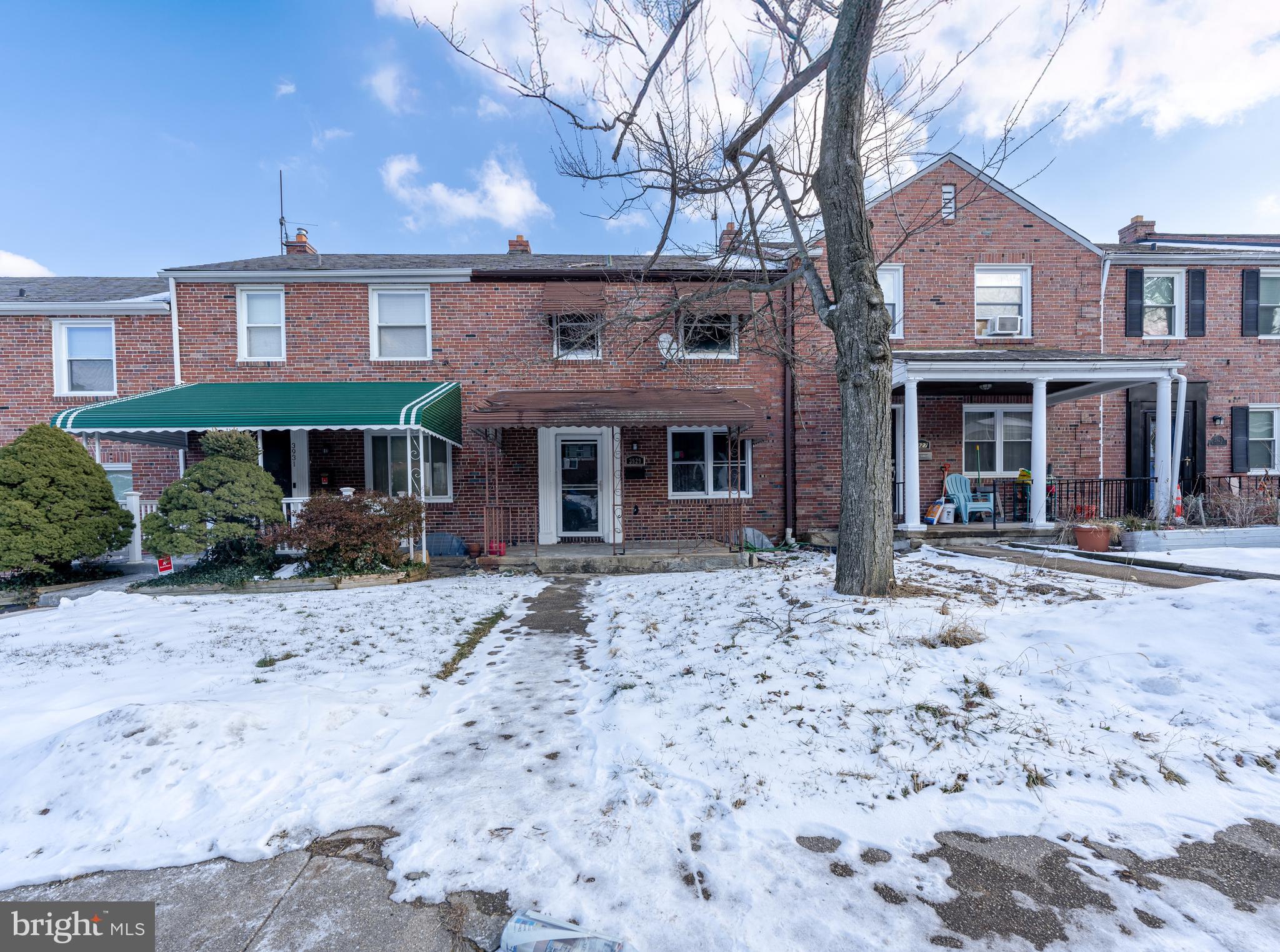 3929 Yolando Road Baltimore, MD 21218 - Photo 1 of 21 a front view of a house with a yard