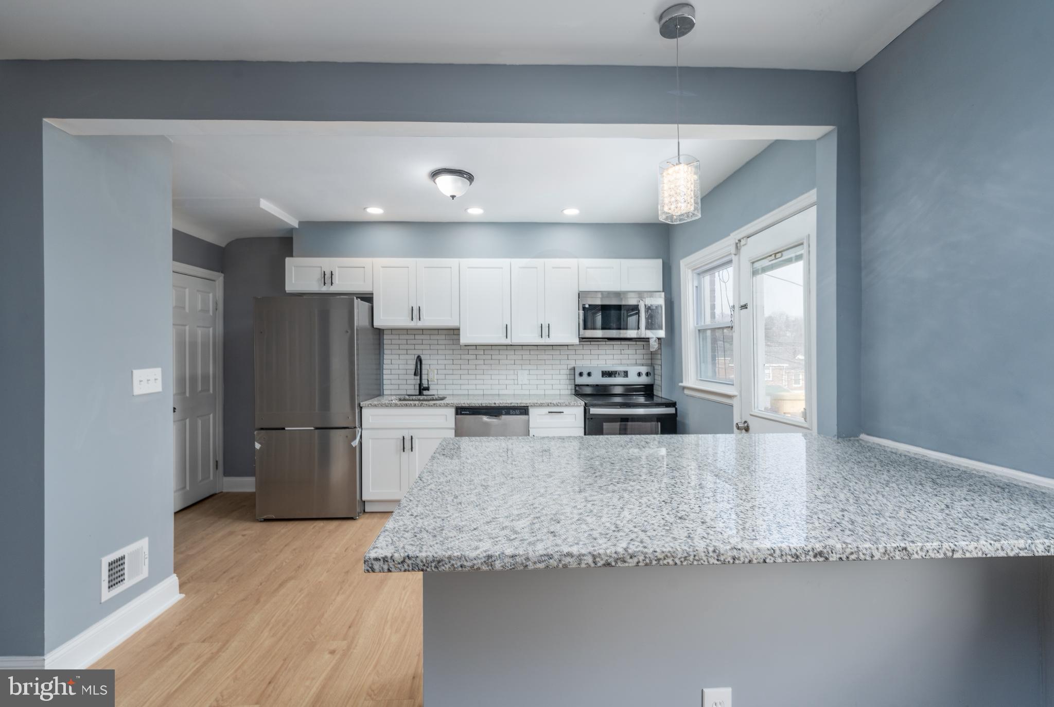 3929 Yolando Road Baltimore, MD 21218 - Photo 5 of 21 a large kitchen with a center island appliances and cabinets