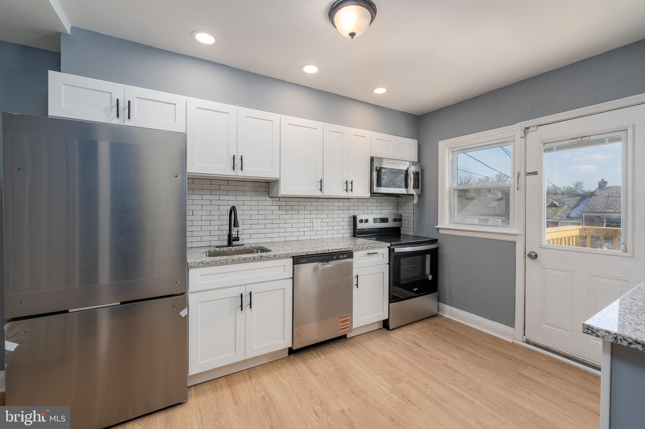 3929 Yolando Road Baltimore, MD 21218 - Photo 6 of 21 a kitchen with stainless steel appliances a refrigerator sink and cabinets