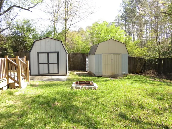 a backyard of a house with table and chairs