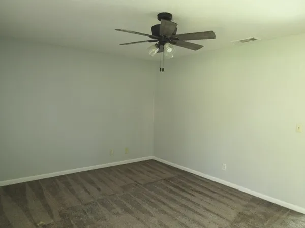 a view of a small space with wooden floor and a window