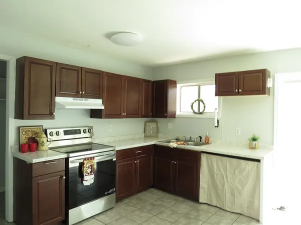 a kitchen with a sink and a stove