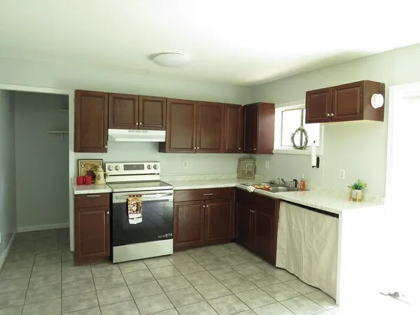 a kitchen with stainless steel appliances granite countertop a sink and cabinets