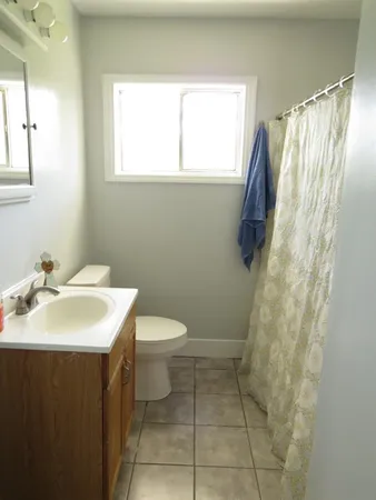 a bathroom with a sink toilet and a mirror