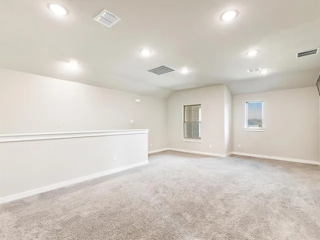 an empty room with a empty space and windows