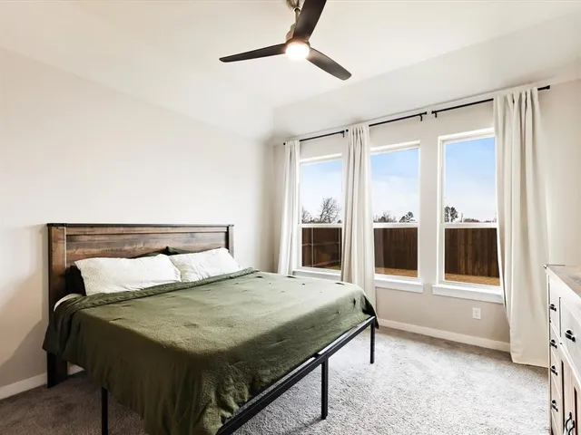 a bedroom with a bed and glass walk in closet