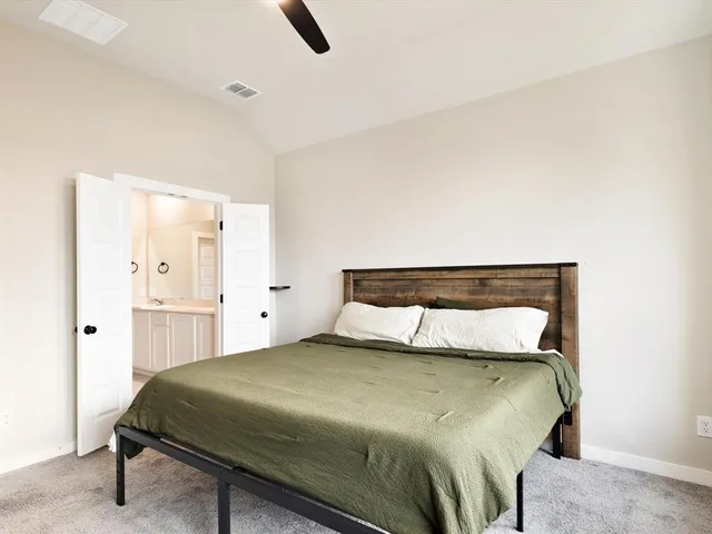 a bedroom with a bed and cabinets