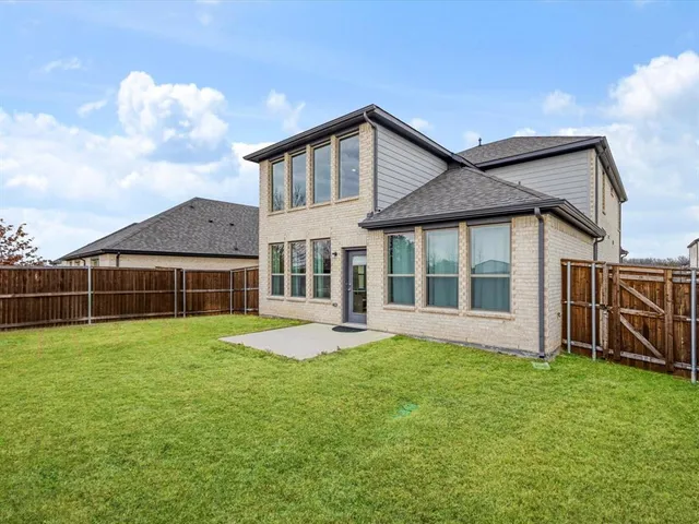 a view of a house with a yard and sitting area