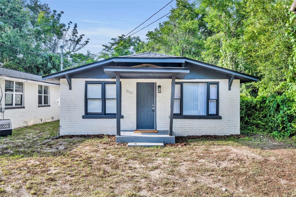 2107 Hollywood Avenue Eustis, FL 32726 - Photo 1 of 1 a front view of a house with a garden