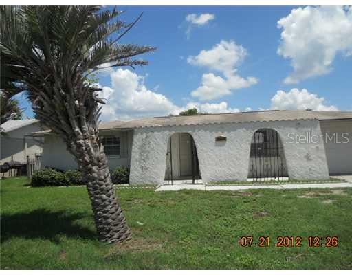 6221 Cecelia Drive New Port Richey, FL 34653 - Photo 1 of 1 a front view of house with yard and green space