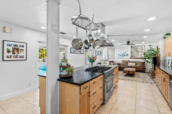 a kitchen with granite countertop a sink and cabinets