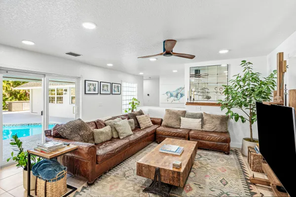a kitchen with stainless steel appliances kitchen island granite countertop a refrigerator and a sink