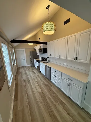 a large kitchen with stainless steel appliances granite countertop a lot of counter space and cabinets