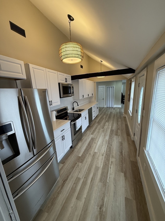 44 South Street Ware, MA 01082 - Photo 15 of 42 a open kitchen with stainless steel appliances granite countertop a stove oven a refrigerator and a fireplace with wooden floor
