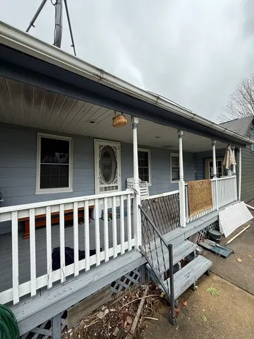 a view of a house with a wooden deck