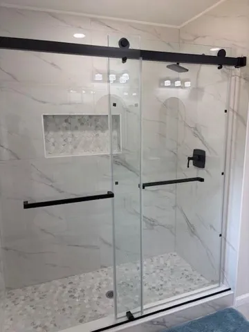a bathroom with a glass shower door