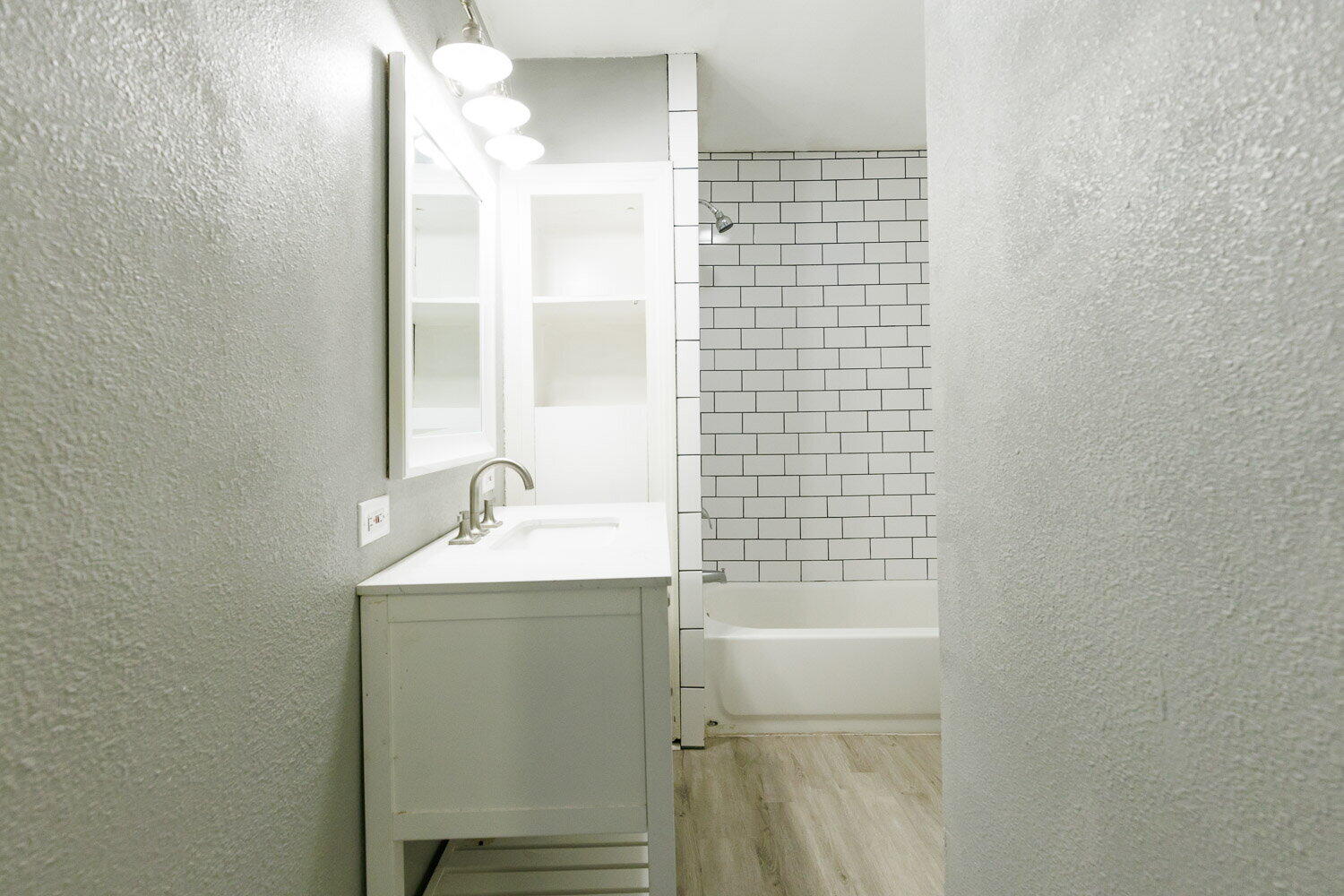 3605 26th Street Lubbock, TX 79410 - Photo 12 of 21 a bathroom with a sink and a mirror