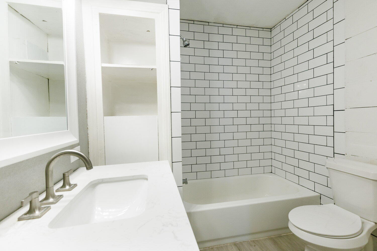 3605 26th Street Lubbock, TX 79410 - Photo 13 of 21 a bathroom with a sink a toilet and bathtub