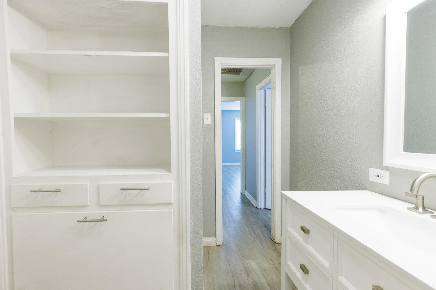 3605 26th Street Lubbock, TX 79410 - Photo 15 of 21 a bathroom with a granite countertop sink a mirror and a bathtub