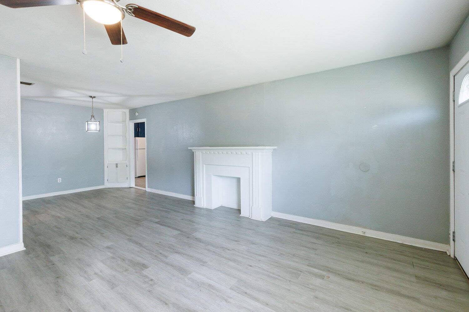 3605 26th Street Lubbock, TX 79410 - Photo 2 of 21 an empty room with wooden floor and windows