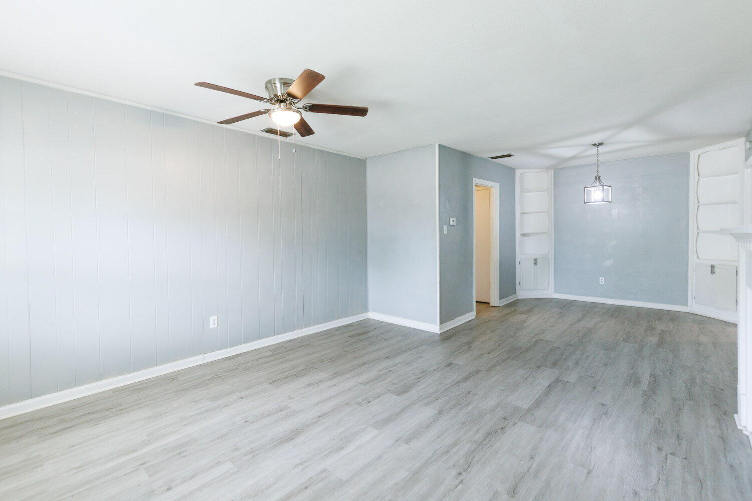 3605 26th Street Lubbock, TX 79410 - Photo 3 of 21 an empty room with wooden floor a ceiling fan and closet