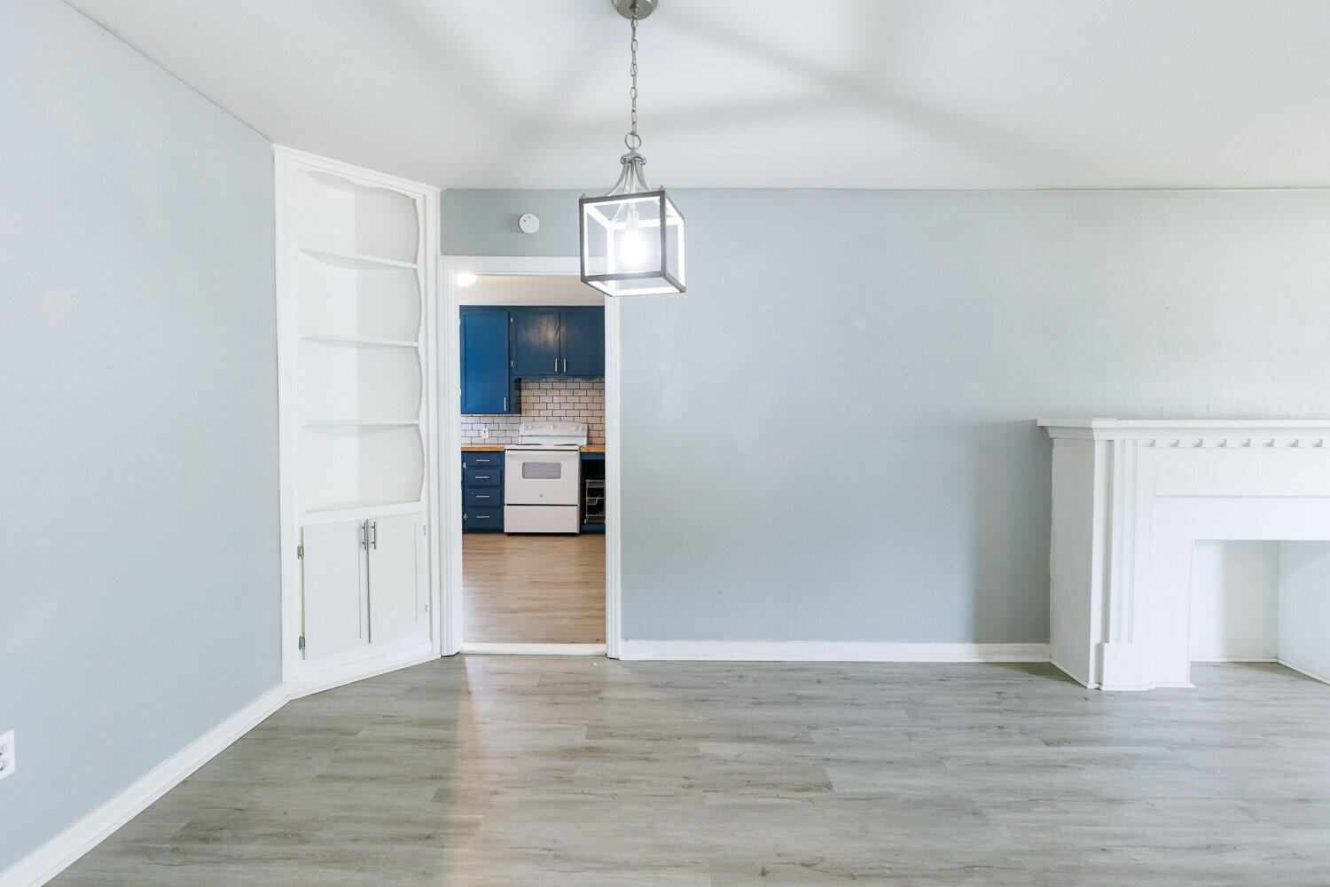 3605 26th Street Lubbock, TX 79410 - Photo 4 of 21 a view of empty room with wooden floor and kitchen