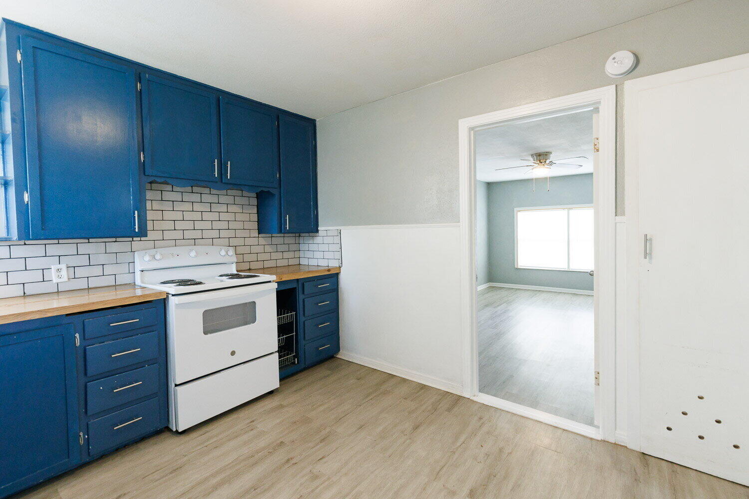 3605 26th Street Lubbock, TX 79410 - Photo 8 of 21 a kitchen with granite countertop wooden cabinets and white appliances