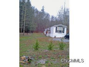 1027 Deep Gap Loop Road Flat Rock, NC 28731 - Photo 1 of 16 a view of a house with a yard