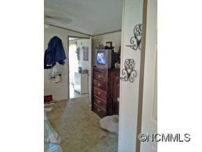 1027 Deep Gap Loop Road Flat Rock, NC 28731 - Photo 11 of 16 a view of walk in closet with clothes