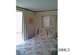 1027 Deep Gap Loop Road Flat Rock, NC 28731 - Photo 13 of 16 a room with a bench and a window