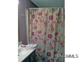 1027 Deep Gap Loop Road Flat Rock, NC 28731 - Photo 16 of 16 a bathroom with a sink and a mirror
