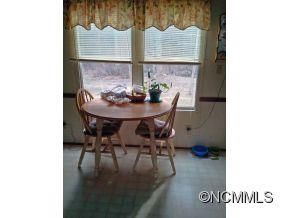 1027 Deep Gap Loop Road Flat Rock, NC 28731 - Photo 5 of 16 a view of a dining room with furniture and wooden floor