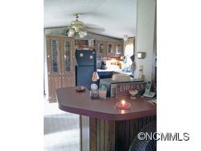 1027 Deep Gap Loop Road Flat Rock, NC 28731 - Photo 6 of 16 a view of a dining room with furniture and chandelier