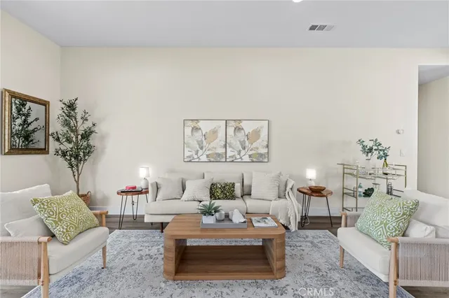 a living room with furniture and a potted plant