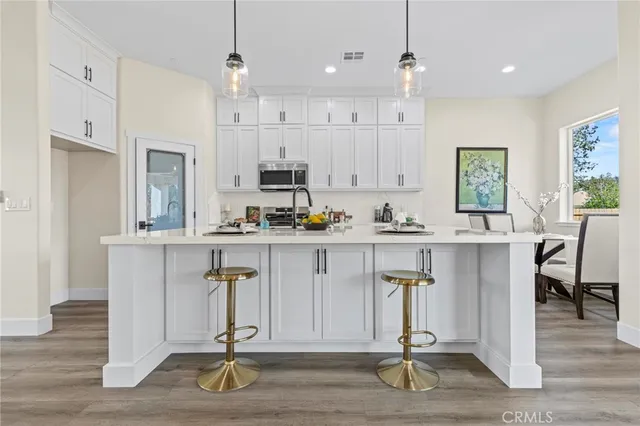 a view of kitchen with refrigerator and window